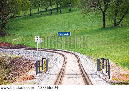 New Renovated Railroad In Small Village With Blue Signboard And Name Of Village Borovnicka In Czech 