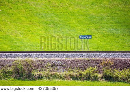 New Renovated Railroad In Small Village With Blue Signboard And Name Of Village Borovnicka In Czech 