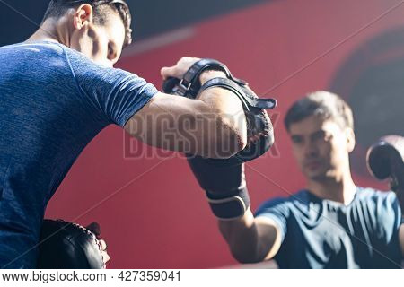 Athlete Boxer Fighter Practice Boxing With Trainer Teacher At Fitness. Caucasian Fitness Instructor 