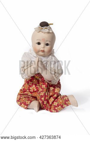 Thai Doll, Kuman Thong, Sitting And Raise Her Hands To Pay Respects According To Thai Tradition.