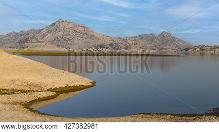 Landscape View Of Jawai Dam With Water And Mountain Ranges At Jawai In Rajasthan India