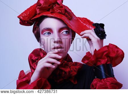Beautiful child girl in a stylish fashionable suit - red hat, scarf, bracelet, neon light, fashion concept