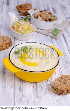 Mashed Potatoes With Butter, Fried Mushrooms With Onions And Salad Of Fresh Vegetables On Light Wood
