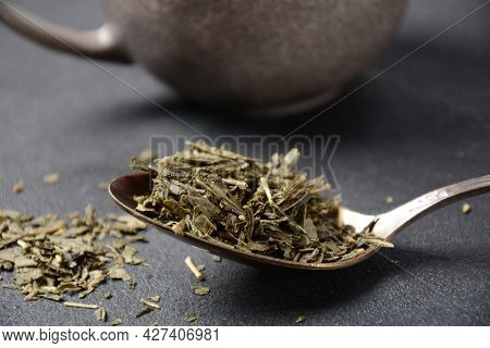 Dry Bancha Green Tea In A Spoon. Japanese Tea