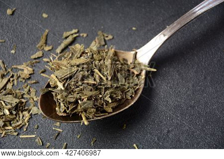 Dry Bancha Green Tea In A Spoon. Japanese Tea