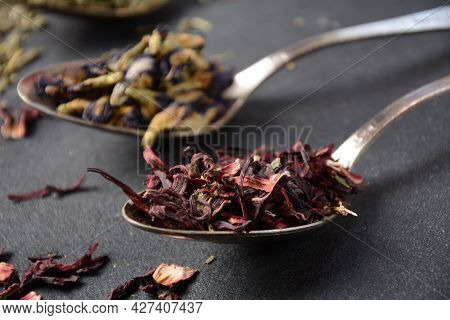 Various Kinds Of Dry Tea Bancha Green, Hibiscus, Butterfly Pea Flower Tea In Spoons On The Table