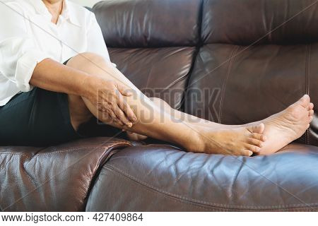 Leg Cramp, Senior Woman Suffering From Leg Cramp Pain At Home, Health Problem Concept