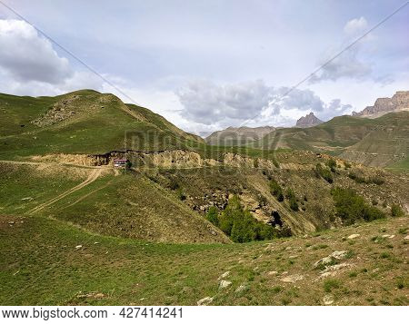 View High Rocky Mountains Surround Gizhgit Lake Against The Backdrop Of Blue Sky. Getting Here Requi