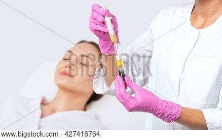 Cosmetologist Does Prp Therapy On The Face Of A Beautiful Woman In A Beauty Salon. Cosmetology Conce