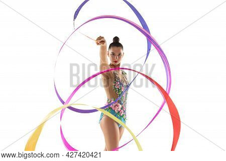 Front View. Half Size Portrait Of Young Female Rhythmic Gymnast Practicing With Colored Ribbon Isola
