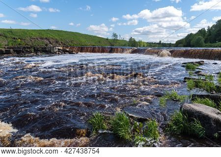 Waterfall On The Tosno River With Rapids And Stony Shore.  Sablino. Leningrad Region. Russia.