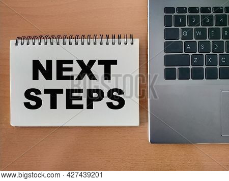 The Concept Of The Next Step For Career Growth In The Company. Word - Next Steps, On Notepad With La