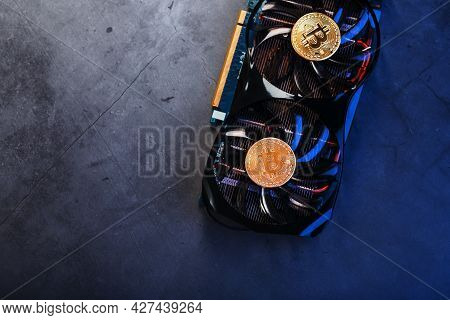Bitcoin Coin On A Powerful Graphics Card For Mining And Earning Cryptocurrency Concept On A Dark Bac