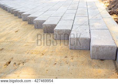 Paving Slabs Or Paving Stones Are Laid Out On The Sand. Process Of Building Footpath. Landscaping, U