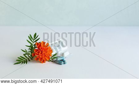 Dietary Supplement Capsules Of Marigold Flowers On White Background. Concept: Vision Improvement, Ey