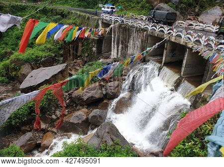 Phuentsholing, Bhutan - May 04, 2019: A Beautiful Fall Of A Himalayan River In Bhutan Below A Bridge