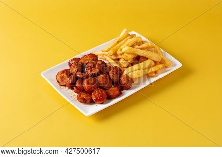 Traditional German Currywurst On Yellow Background. Typical Oktoberfest Food.suasages With Ketchup A