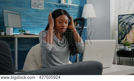 African American Student Blogger Putting Headphones Working Remote From Home At Social Media Articol