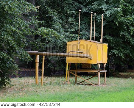 Yellow Metal Box Of A Gas Distributor In A Green Garden