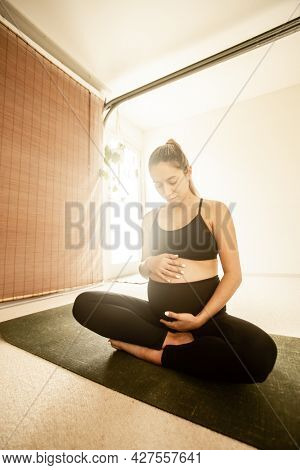 young pregnant woman practicing maternity yoga