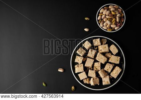 Organic Halva With Pistachios On Black Background. Traditional Middle Eastern Sweets. Jewish, turkis