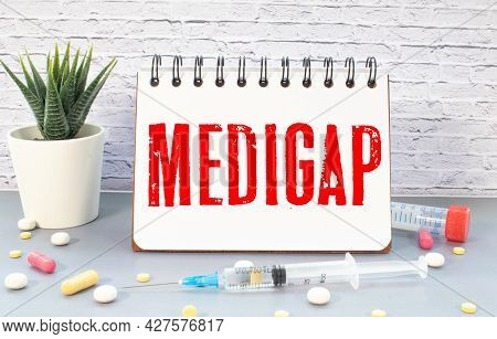 Medigap Text Written In A Notebook Lying On A Desk And A Stethoscope. Medical Concept