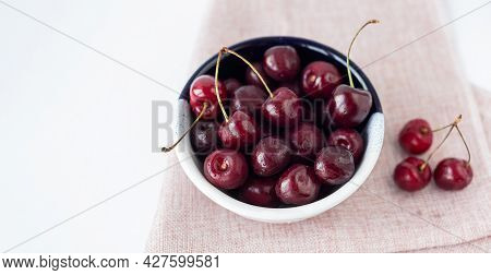 Bowl Of Cherries On Pink Linen Napkin. Top View. Sweet, Ripe Berries With Water Drops. Summer Harves