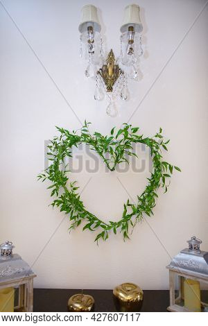 Decorating The Venue During The Reception By Arranging A Heart Symbol From A Ruscus Plant.