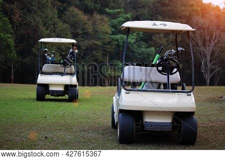 Golfcar In Beautiful Golf Course In The Evening Golf Course With Sunshine In Thailand