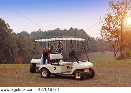 Golfcar In Beautiful Golf Course In The Evening Golf Course With Sunshine In Thailand