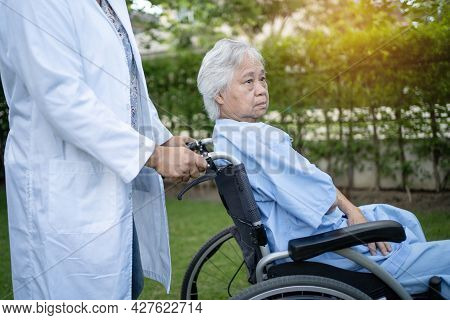 Doctor Help And Care Asian Senior Or Elderly Old Lady Woman Patient Sitting On Wheelchair At Park In