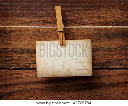 Old Photo Postcard And Clothes Peg On Wood