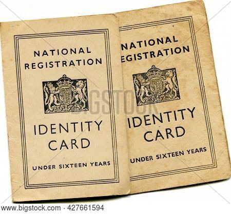 TENTERDEN, ENGLAND - JULY 23, 2021: A pair of British National Identity Cards for children under sixteen. Launched in 1939 at the start of the Second World War, they were discontinued in 1952.