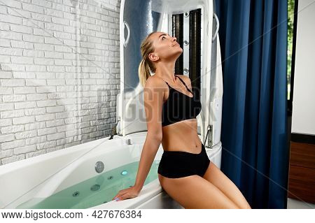 Pretty Woman With Perfect Skin Getting Ready For Spa Beauty Therapy In Spa Capsule. Hydro And Vibrom