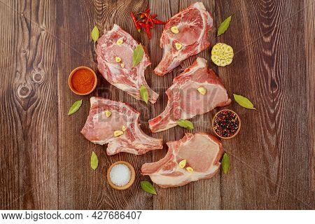 Fresh Pork Meat Bone In On Wooden Background. Top View.