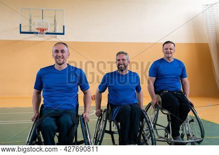 photo of the basketball team of war invalids with professional sports equipment for people with disabilities on the basketball court