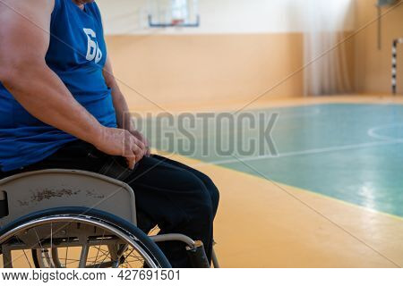 a handicapped basketball player prepares for a match while sitting in a wheelchair.preparations for a professional basketball match. the concept of disability sport