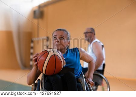 a young woman playing wheelchair basketball in a professional team. Gender equality, the concept of sports with disabilities. 