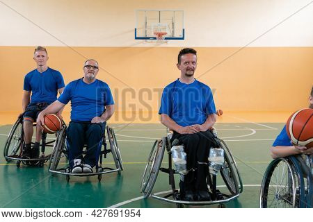 photo of the basketball team of war invalids with professional sports equipment for people with disabilities on the basketball court