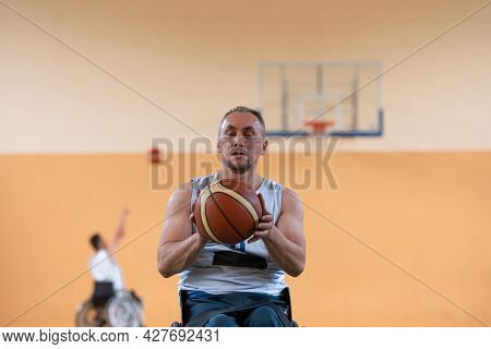 a photo of a war veteran playing basketball with a team in a modern sports arena. The concept of sport for people with disabilities