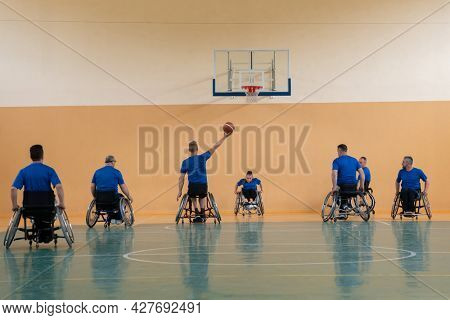 training of the basketball team of war invalids with professional sports equipment for people with disabilities on the basketball court