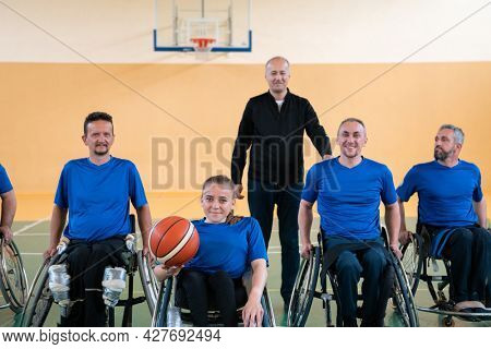 photo of the basketball team of war invalids with professional sports equipment for people with disabilities on the basketball court