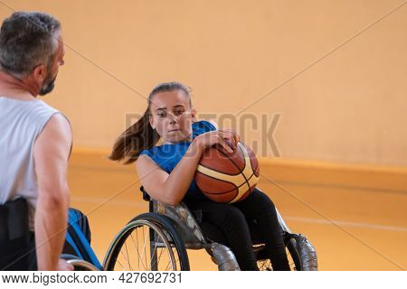 a young woman playing wheelchair basketball in a professional team. Gender equality, the concept of sports with disabilities. 