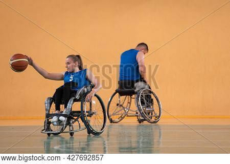 a young woman playing wheelchair basketball in a professional team. Gender equality, the concept of sports with disabilities. 