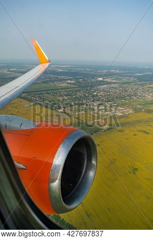Land View Through The Airplane Window. Fields, Roads, Rivers From A Birds Eye View. Porthole. Look O