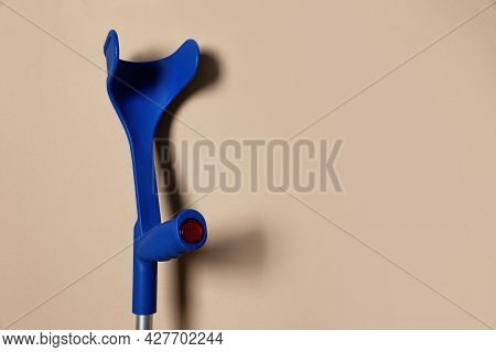 Elbow Crutch On Beige Background. Space For Text