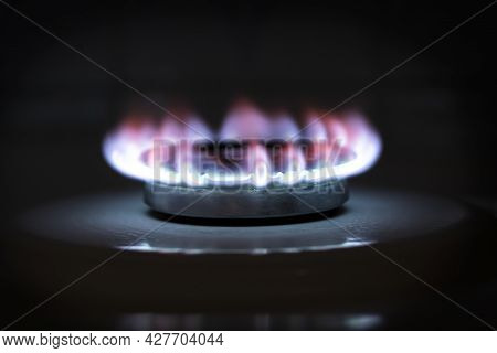 Burning Blue Gas On The Stove. The Flame Of A Burning Gas Fire On A Black Background.