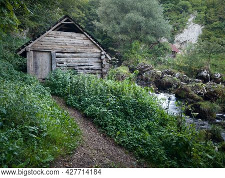 Small Traditional Wooden Water Mill By The Wild River Krupa With Big Rocks And Cascades On Popular T