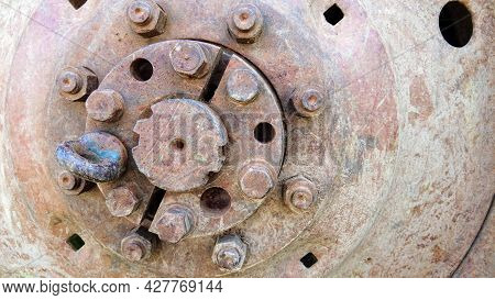 Rusty Tractor Wheel. Technical Background With Corroded Wheel Disc And Hub. Old Tractor Or Heavy Agr