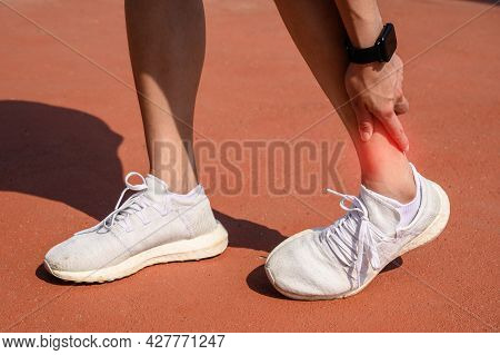 Cropped Shot Of Runner Woman Suffering From Ankle Pain. Ankle Pain May Be Caused By An Injury, Like 